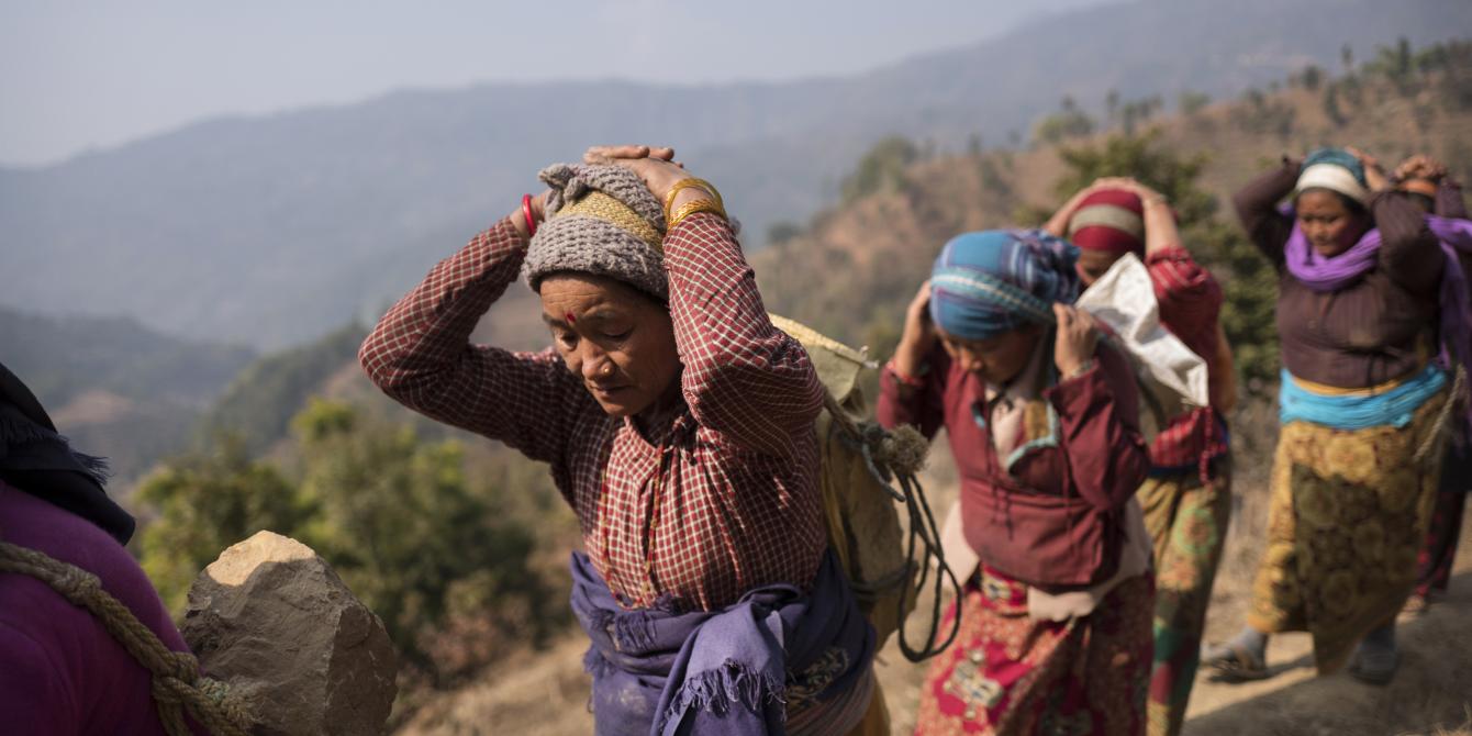 The communities living in Ghairung, Ghorka, take part in an Oxfam-funded Cash for work scheme to rebuild a 5km trail destroyed by the massive 7.6 magnitude earthquake that struck Nepal in 2015. The trail connects two villages, a health centre, and a local market and will benefit 1,140 households. The earthquake left nearly 9,000 people dead and destroyed or damaged more than 850,000 homes. Photo: Kieran Doherty / Oxfam Communities in Nepal
